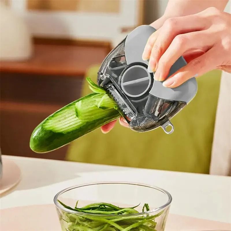 TriPeel 3-in-1 rotary peeler slicing a cucumber into julienne strips